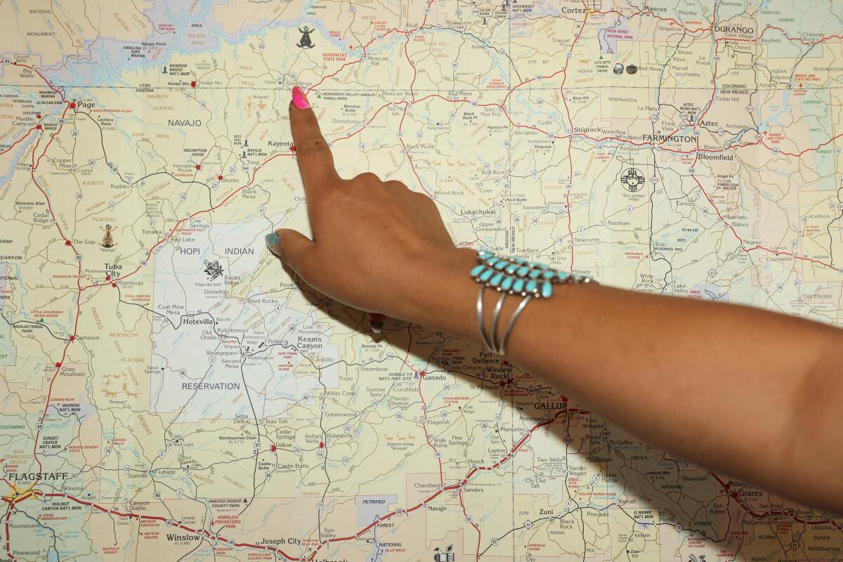 Emma Robbins points to a village on a map of the Navajo Nation.