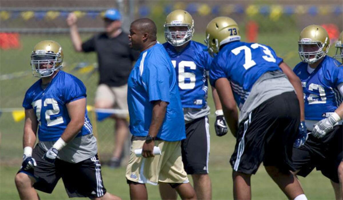 UCLA offensive line coach Adrian Klemm, center, has received a two-year contract worth $340,000 in 2013 and $350,000 in 2014, in addition to a $40,000 retention bonus to be paid in 2015.