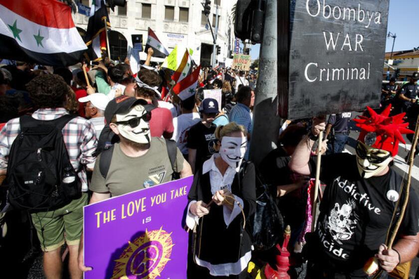 Hundreds of people at Hollywood Boulevard and Highland Avenue in Hollywood on Sunday protest the possibility of a U.S. strike against Syria.