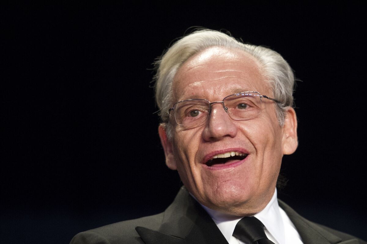 FILE - In this April 29, 2017, file photo journalist Bob Woodward sits at the head table during the White House Correspondents' Dinner in Washington. Woodward, facing widespread criticism for only now revealing President Donald Trump's early concerns about the severity of the coronavirus, told The Associated Press that he needed time to be sure that Trump's private comments from February were accurate. (AP Photo/Cliff Owen, File)