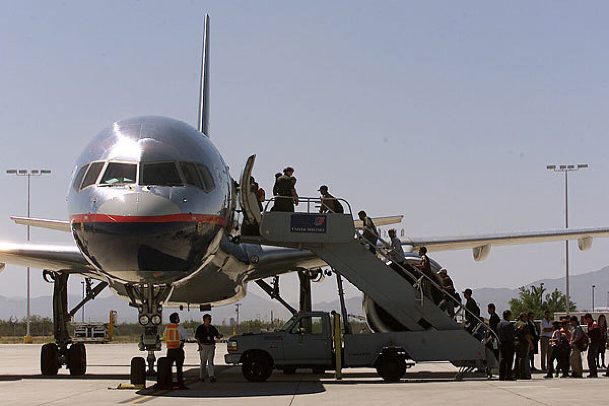 Immigrants are led onto a flight in the United States.