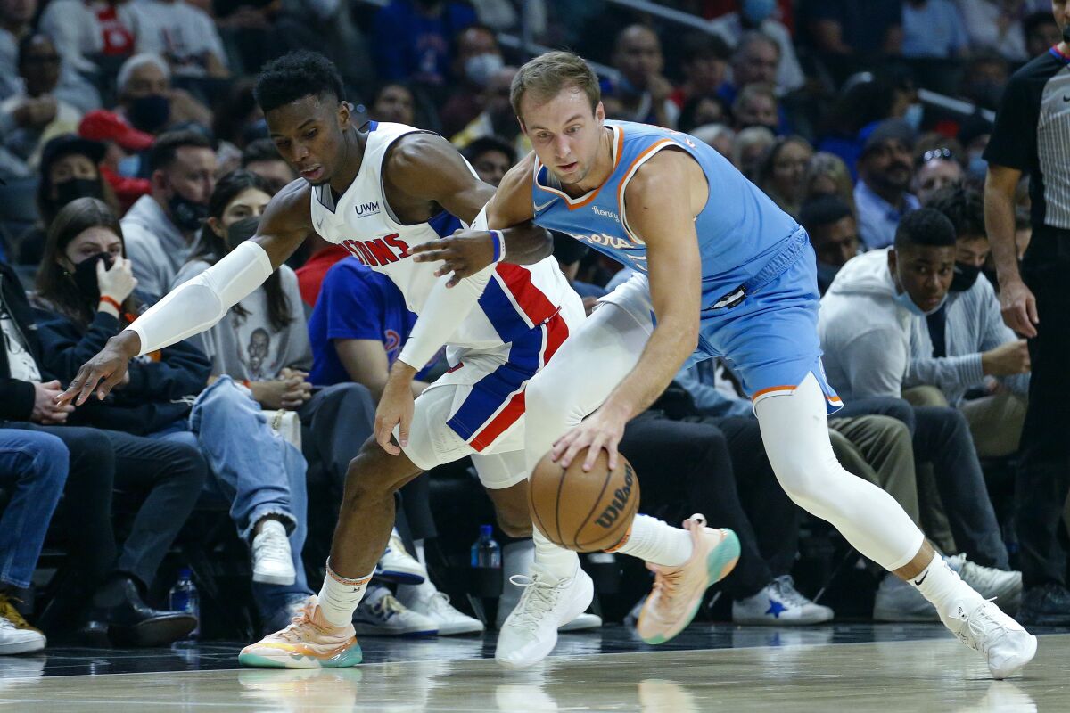 Clippers guard Luke Kennard tries to control the ball while pressured by Pistons guard Hamidou Diallo.