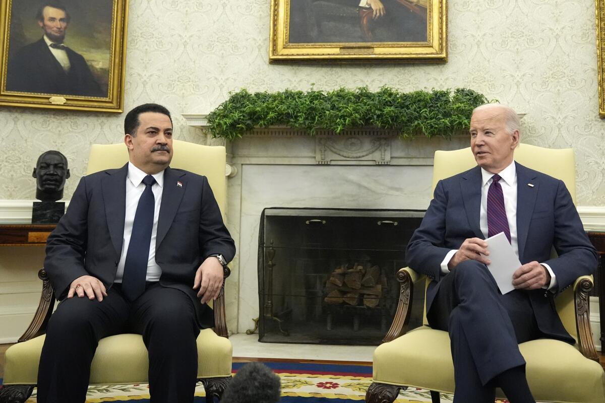 President Biden and Iraq's Prime Minister Shia al-Sudani sit in the Oval Office of the White House.