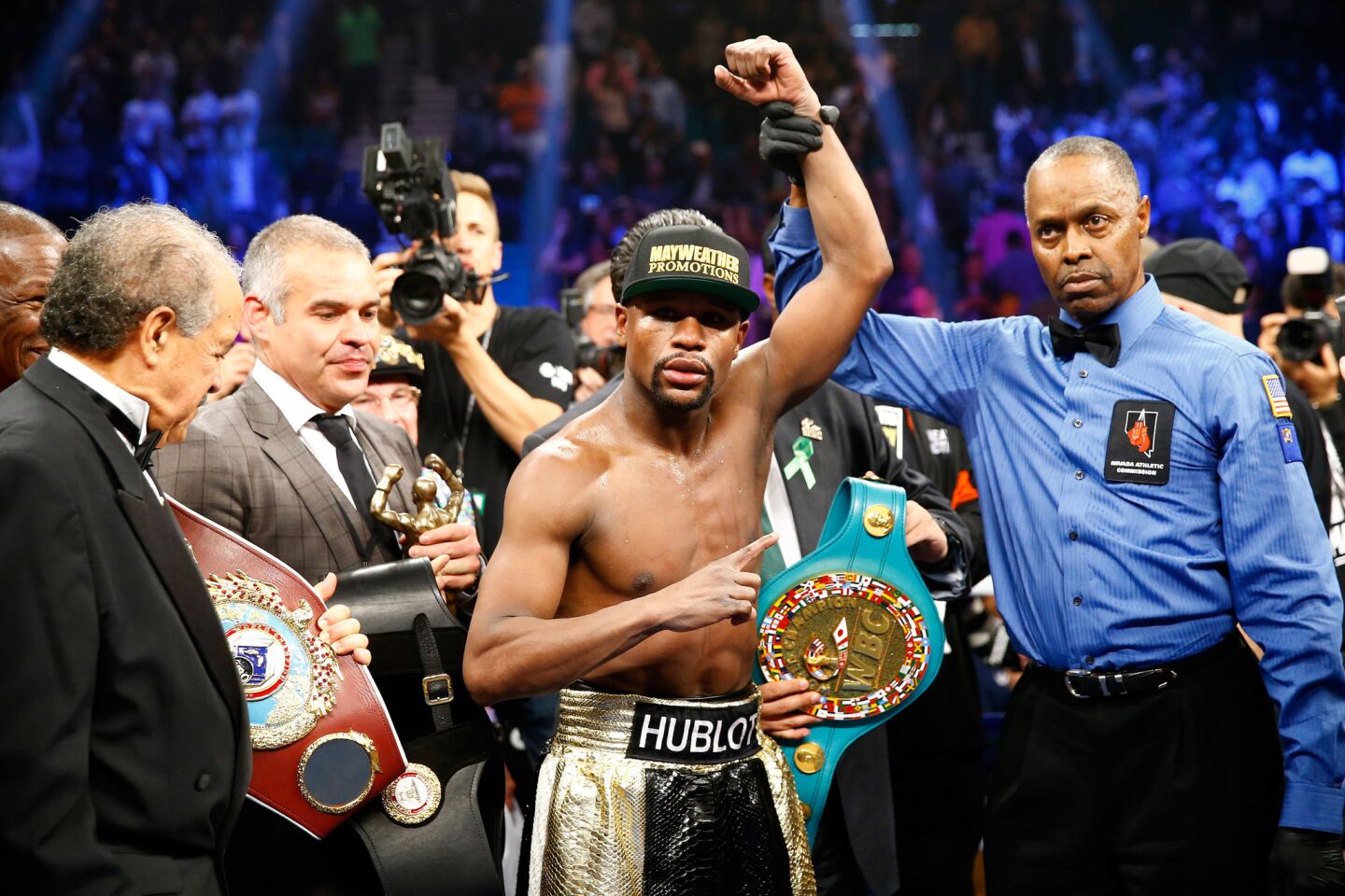 Floyd Mayweather Jr. retained his welterweight title by defeating Manny Pacquiao by unanimous decision.