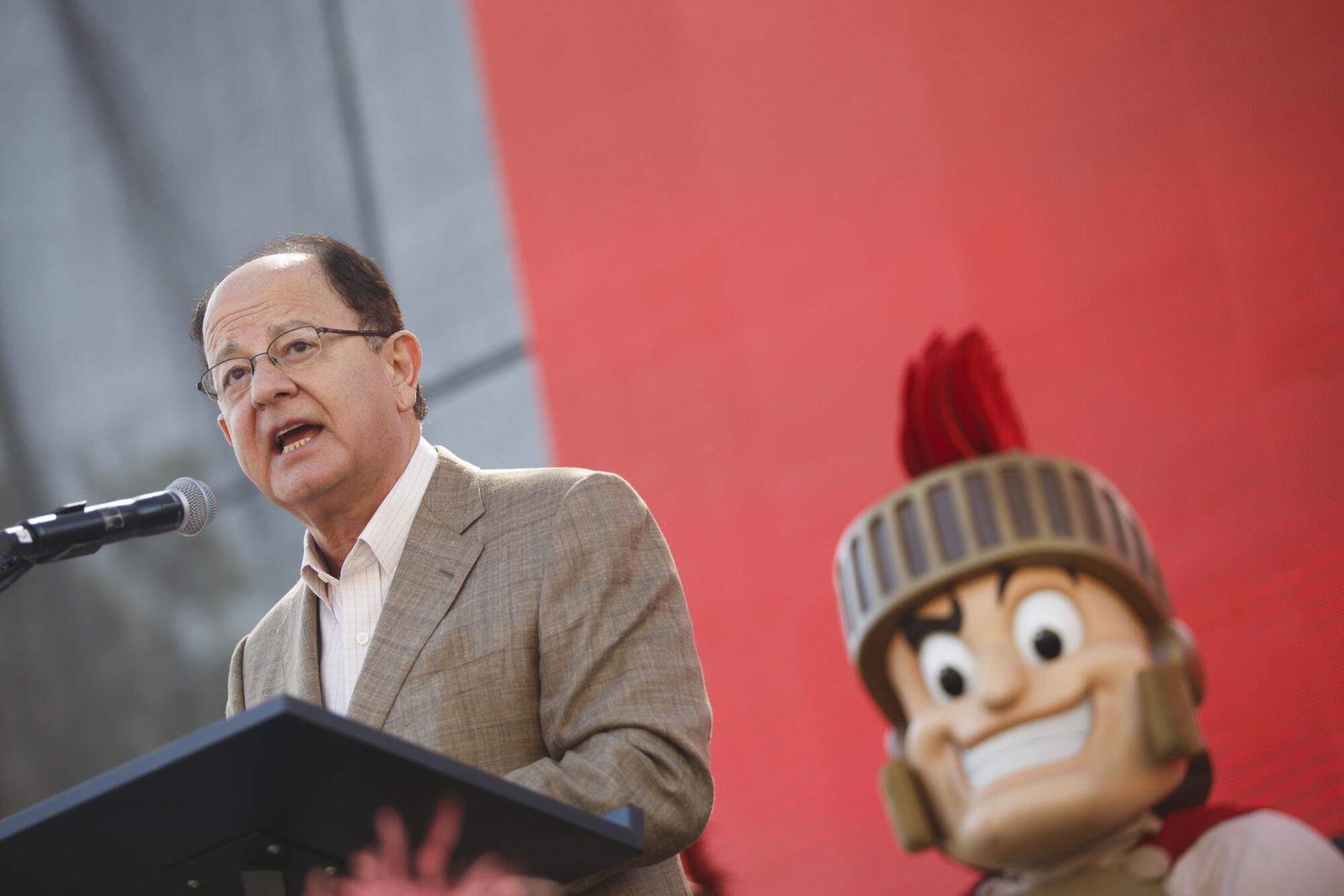 April 2017 of then-USC President C. L. Max Nikias is joined by Tommy Trojan in Los Angeles.