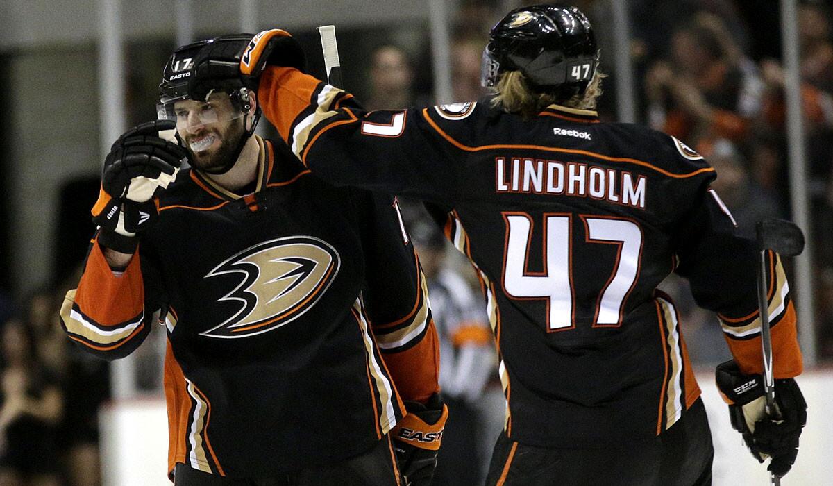 Ducks center Ryan Kesler is congratulated by teammate Hampus Lindholm after scoring the clinching goal in a shootout win over the Predators on Sunday night at Honda Center.