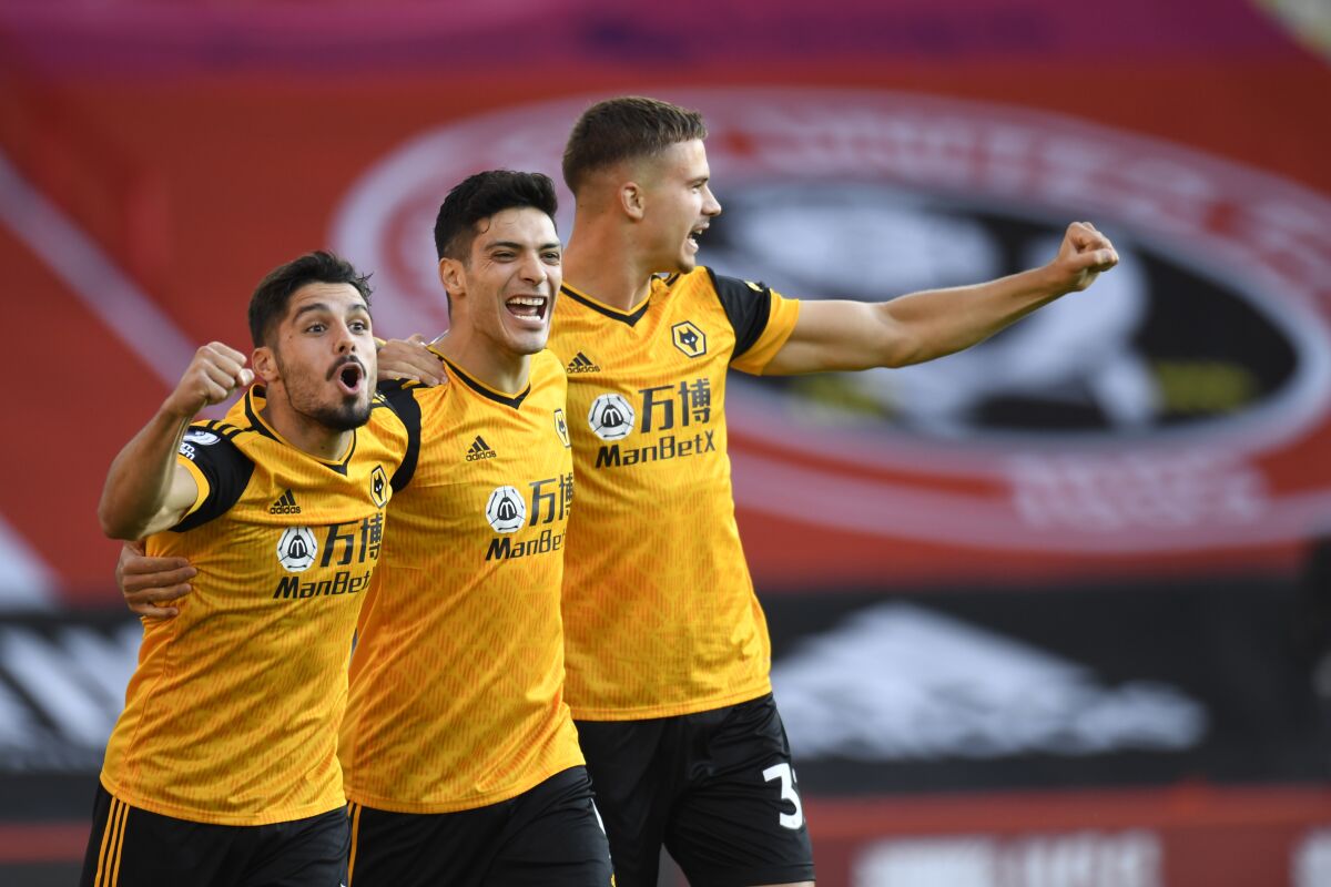 Wolverhampton Wanderers' Raul Jimenez, centre, celebrates scoring his sides first goal during the English League Cup soccer match between Sheffield United and Wolves at Bramall Lane stadium in Sheffield, England, Monday, Sept. 14, 2020. (Peter Powell/Pool via AP)
