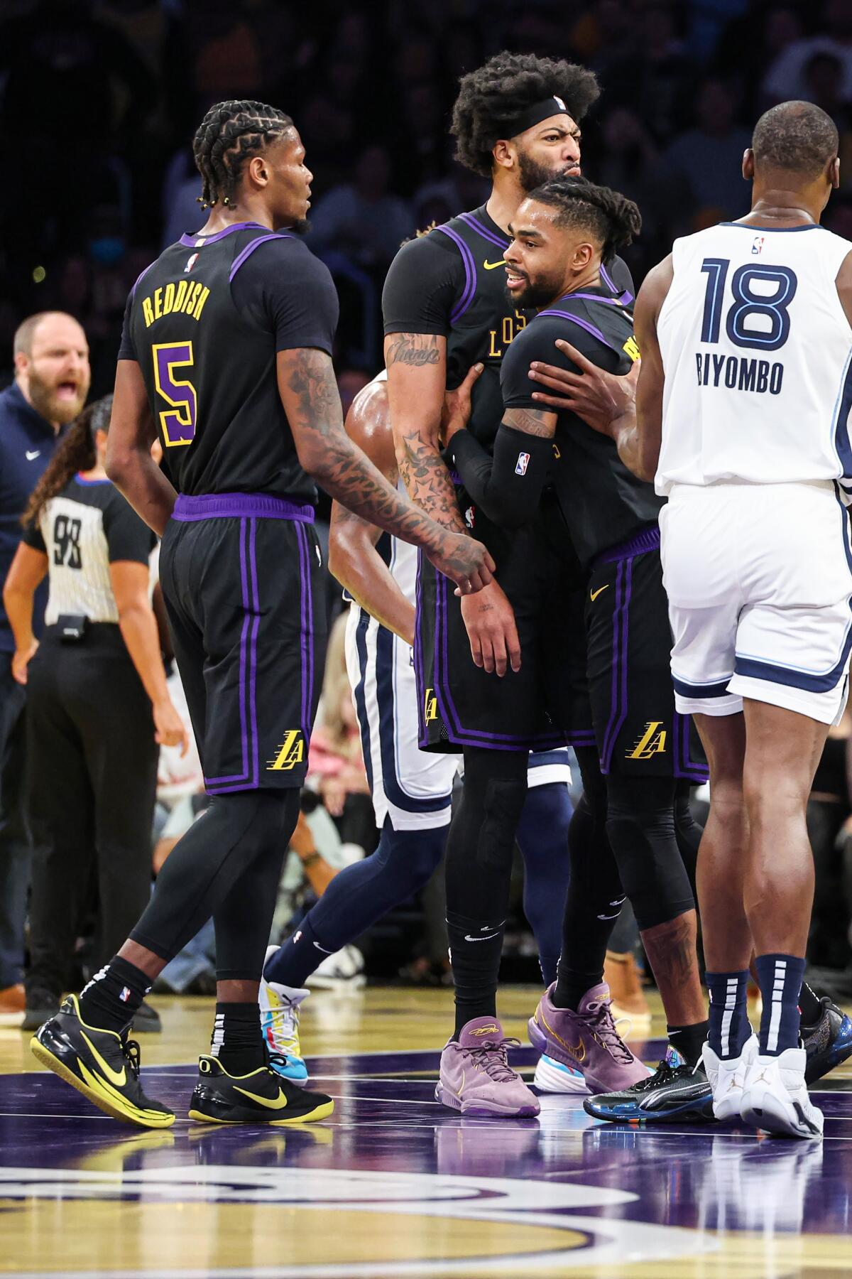  Anthony Davis is held back by teammate D'Angelo Russell after getting into an altercation with  Memphis' Santi Aldama.