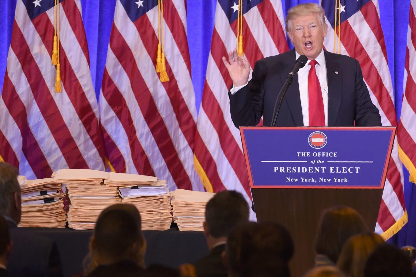 Numerous files are displayed as President-elect Donald Trump gives a press conference Jan. 11, 2017, in New York.