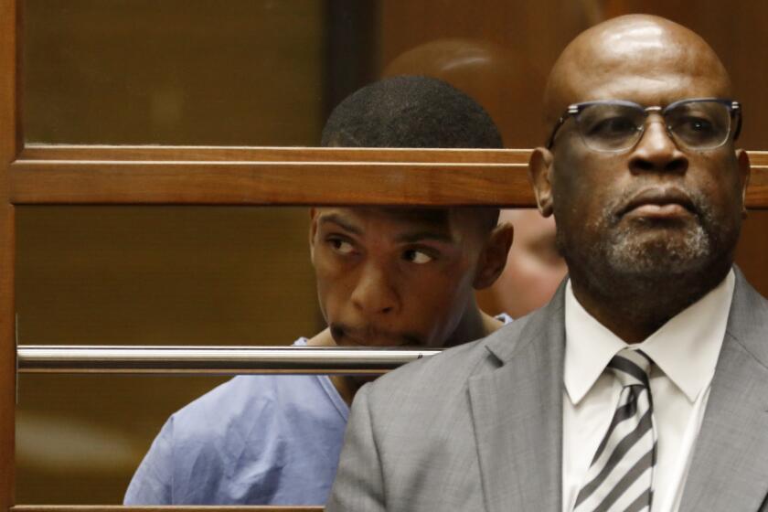 LOS ANGELES, CA APRIL 4, 2019: Chris Darden, right, former OJ Simpson prosecutor is representing Eric Holder, left, charged with the murder of Nipsey Hussle in court in Los Angeles, CA April 4, 2019.. (Francine Orr/ Los Angeles Times)