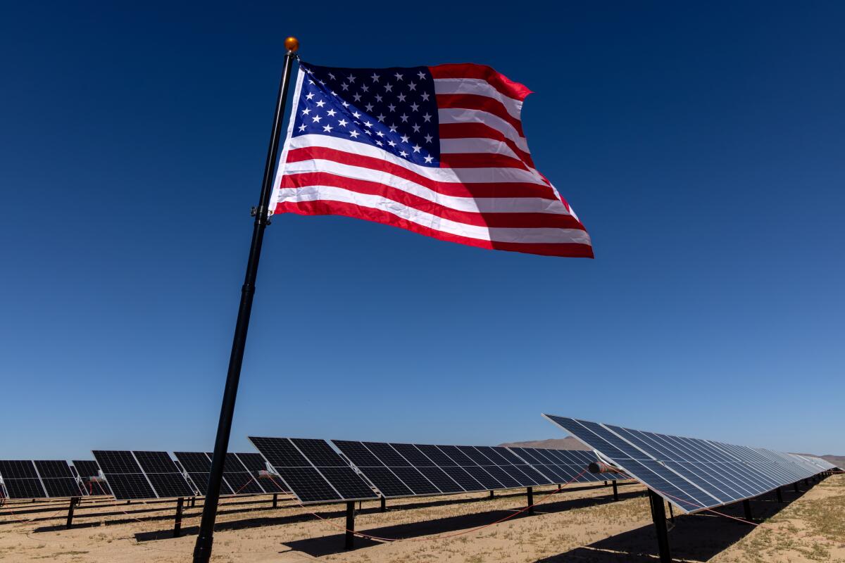 A U.S. flag flies at a solar farm