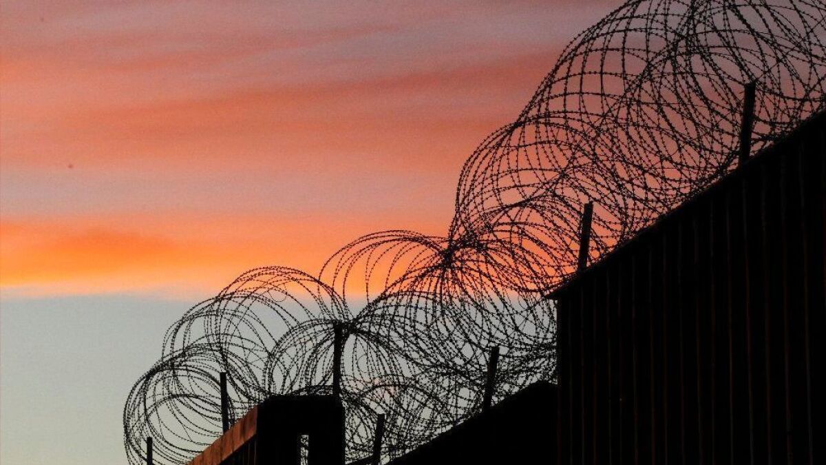 Razor wire tops the U.S.-Mexico border barrier at Tijuana.