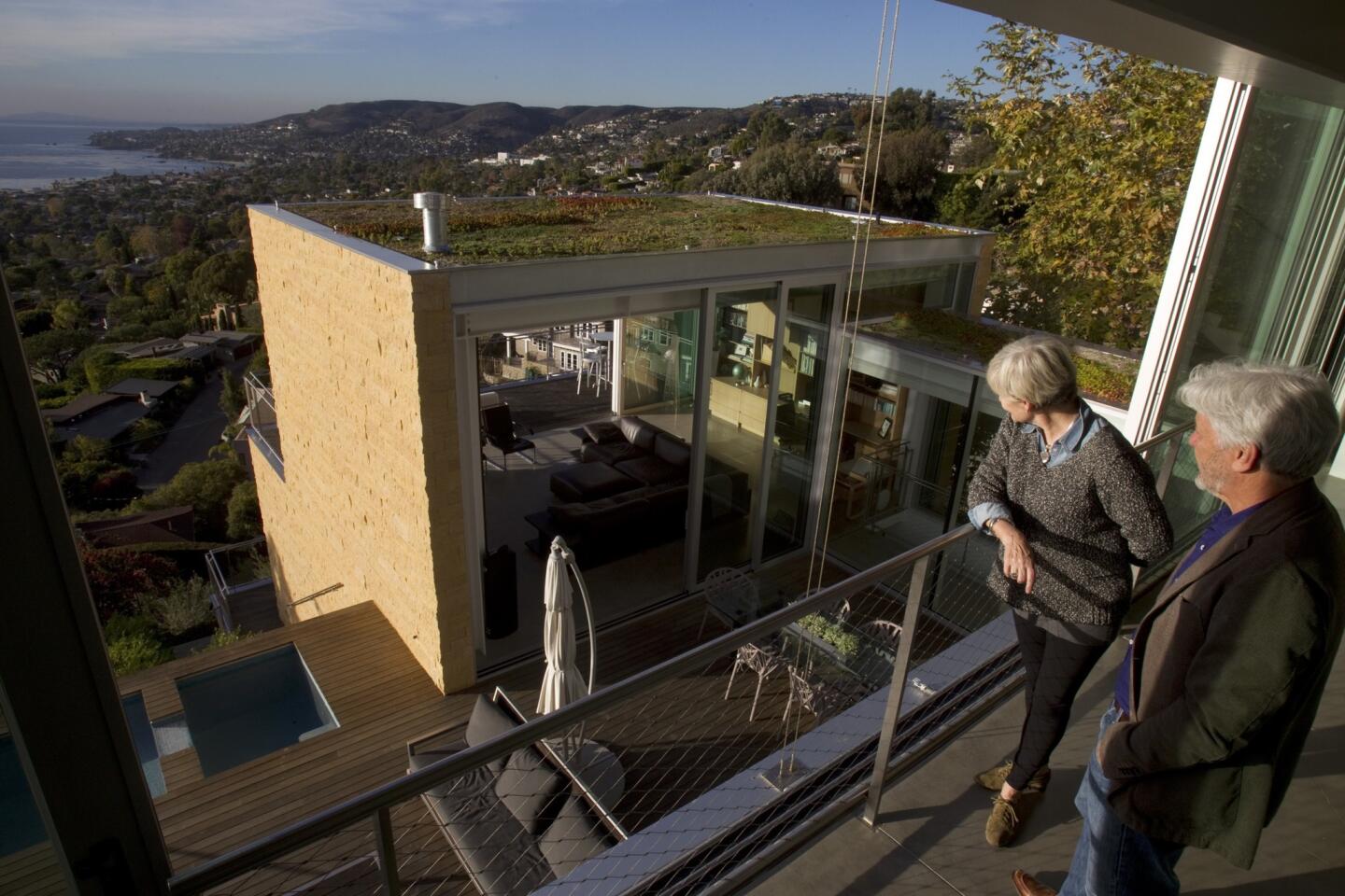 Paul and Susan Zafjen soak in the late-afternoon sun from their master suite, which opens to a glorious view of Laguna Beach.