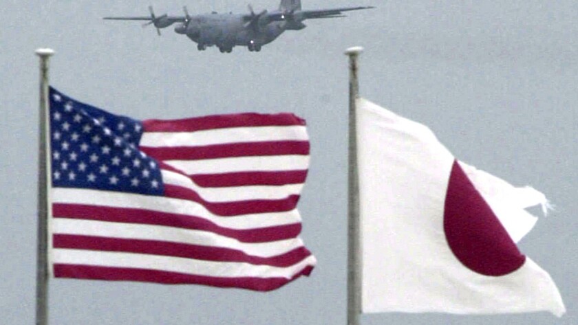 Flags of U.S. and Japan flutter in U.S. Kadena Air Base on the southern island of Okinawa in Japan on Sept. 23, 2001.