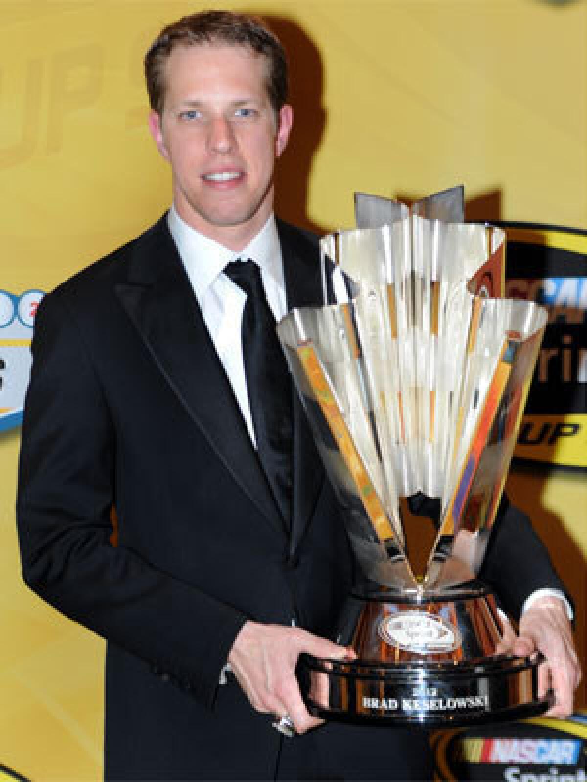 Brad Keselowski poses with his championship trophy after the NASCAR Sprint Cup Series awards ceremony at the Wynn in Las Vegas on Nov. 30.