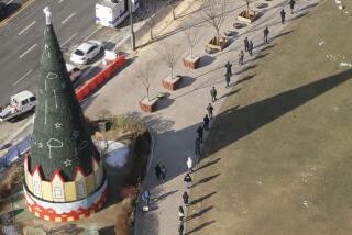 People line up for coronavirus testing in Seoul.