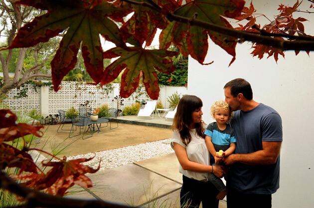 Laura Haskell, Laird Stoneman and Andrew Stoneman stand under a Japanese maple at the front of their 1960 house. The couple created an elegantly spare courtyard in front of the 1,500 square-foot home using patterned cinder blocks. "I liked the motif," Haskell says of the blocks, though she adds that there aren't as many options as one might think.