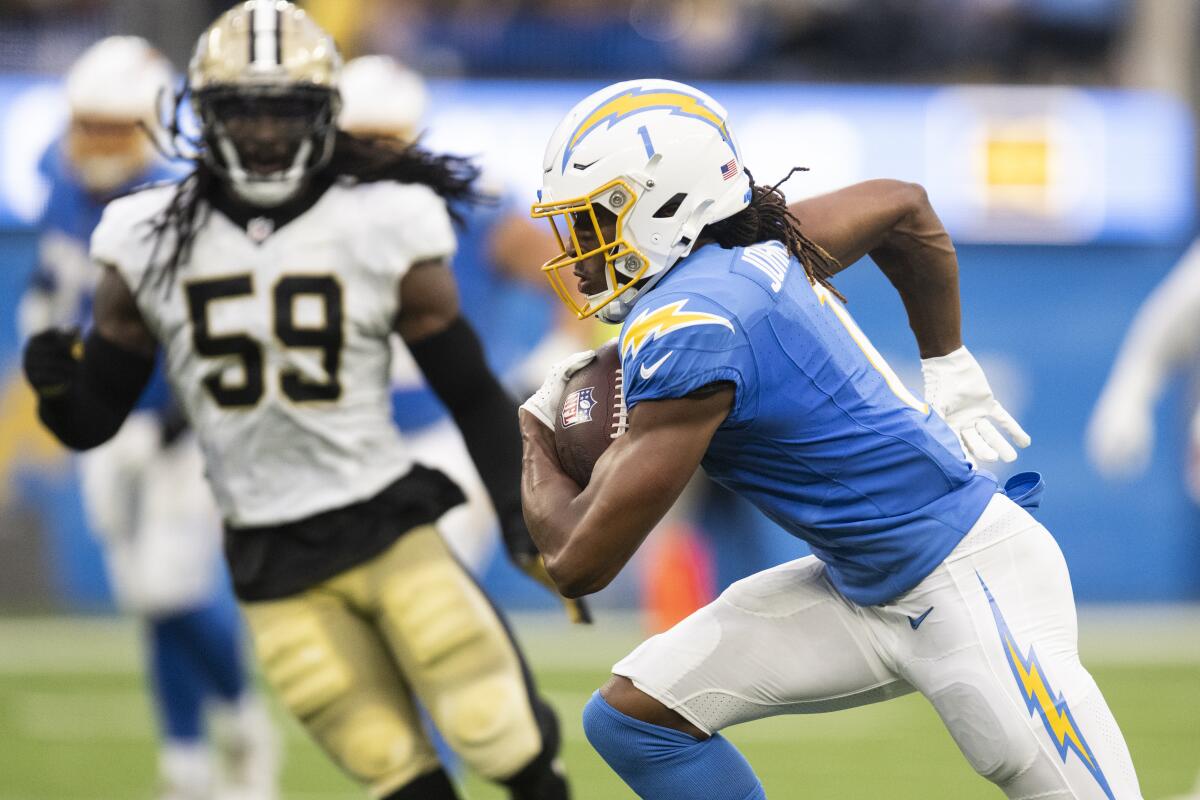 Chargers wide receiver Quentin Johnston runs with the ball during preseason game.