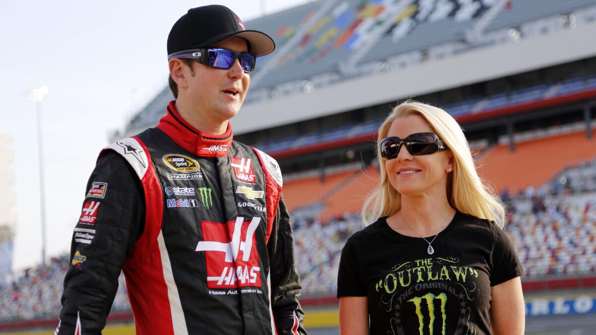 Kurt Busch, left, stands next to then-girlfriend Patricia Driscoll before qualifying at Charlotte Motor Speedway in Concord, N.C., on May 22, 2014.