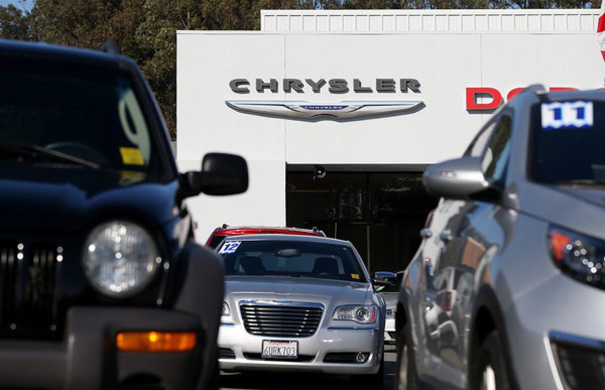 Cars are displayed on the sales lot of a Chrysler dealership on January 3, 2013 in Colma, California. Analytics giant IHS Inc. said it has signed an agreement to acquire R.L. Polk & Co. for $1.4 billion.