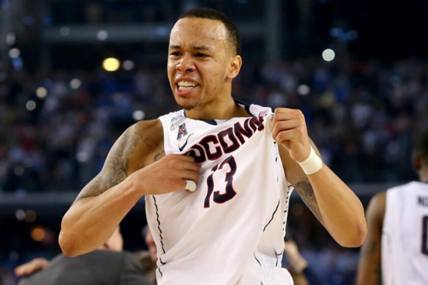 Connecticut's Shabazz Napier celebrates the Huskies' 60-54 national title victory over Kentucky on Monday.