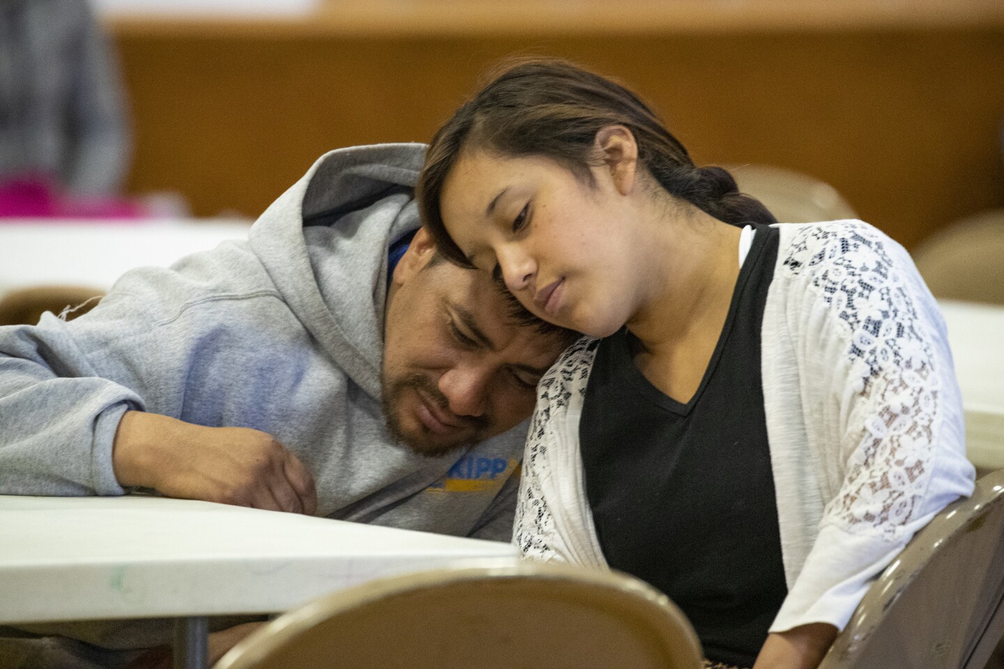Luis Macario, 38, left, and his 17-year-old daughter Yenifer Macario Lopez relax at Blythe Central Seventh-Day Adventist Church after they were dropped off by U.S. Border Patrol agents.