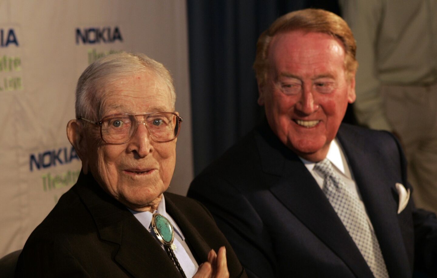 Vin Scully listens to legendary UCLA coach John Wooden at an interview in June 2008.
