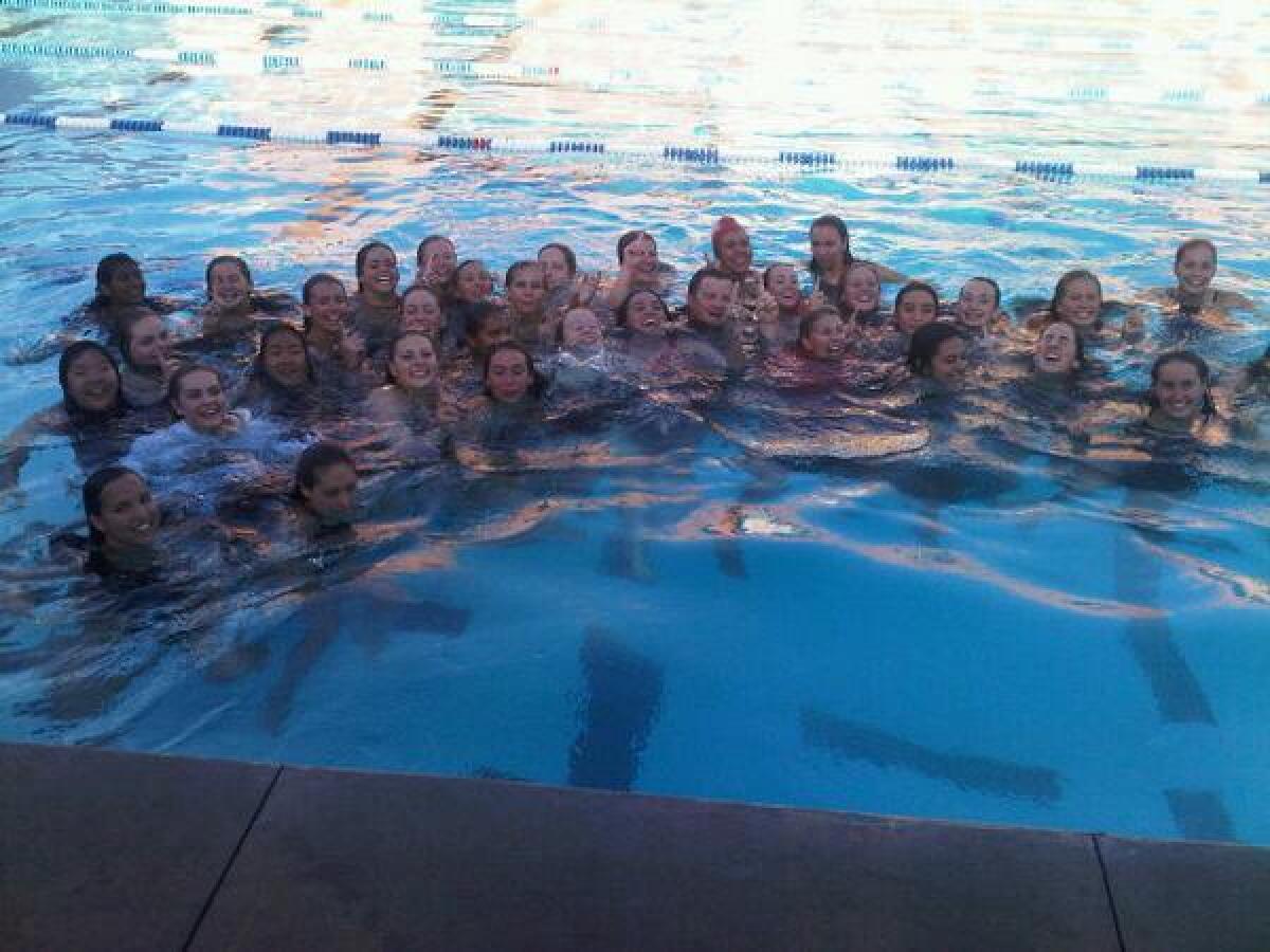 The Flintridge Sacred Heart Academy swim team celebrated repeating in Mission League outright by jumping in the pool after a dual meet with Chaminade.
