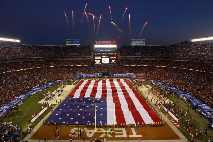 The giant flag covers the field before the Holiday Bowl on Wednesday, Dec. 28, 2011.