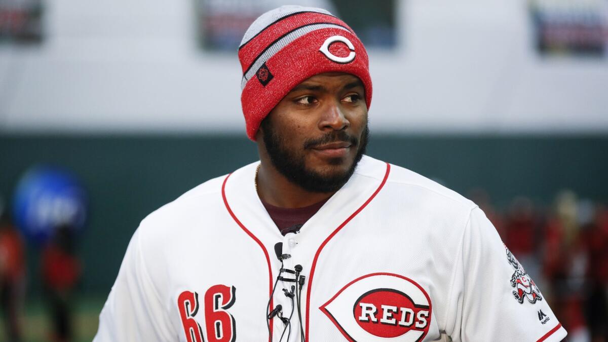 Cincinnati Reds right fielder Yasiel Puig answers questions from reporters at the Reds Youth Academy on Jan. 30.