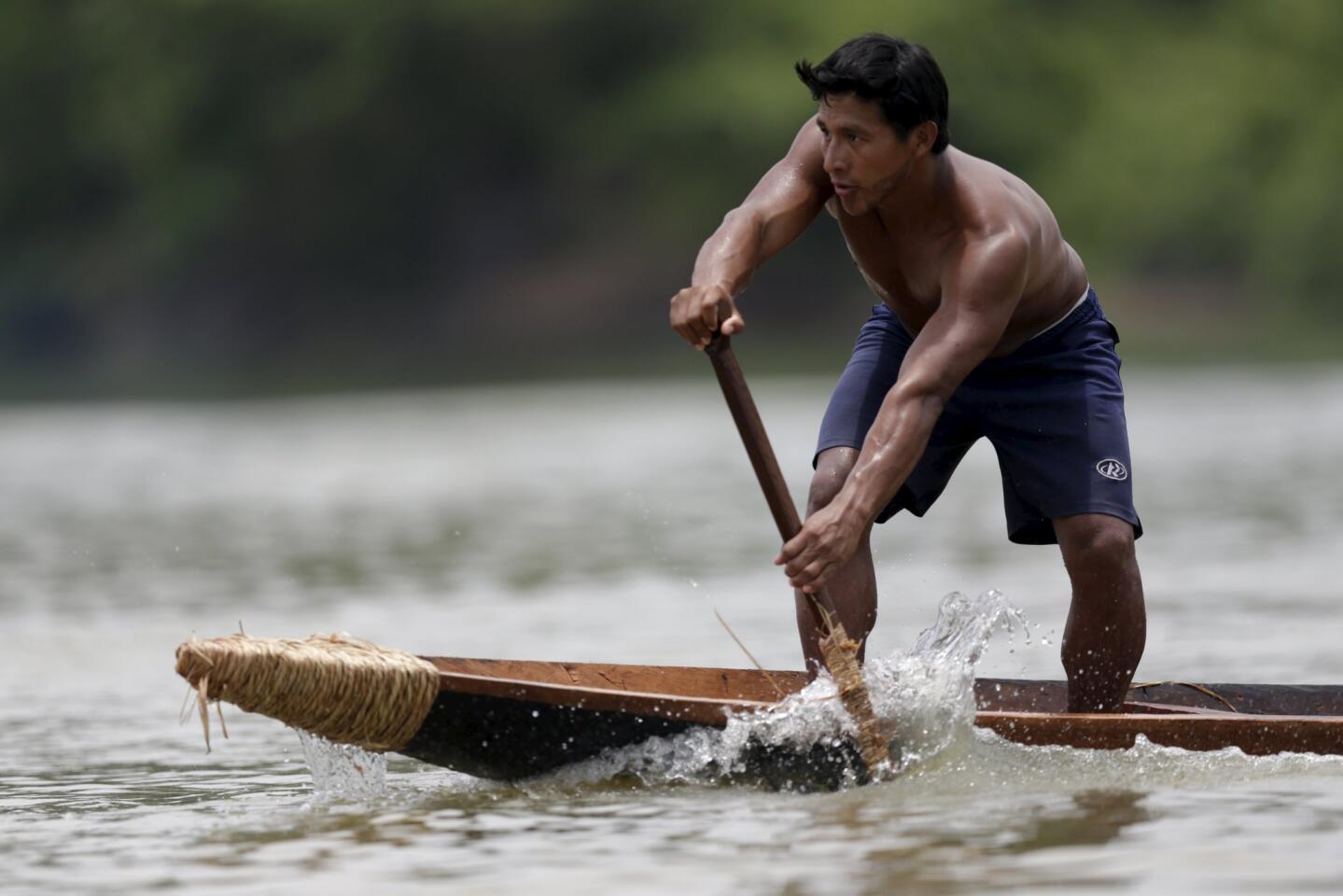 A indigenous man practices canoeing during the first World Games for Indigenous Peoples in Palmas