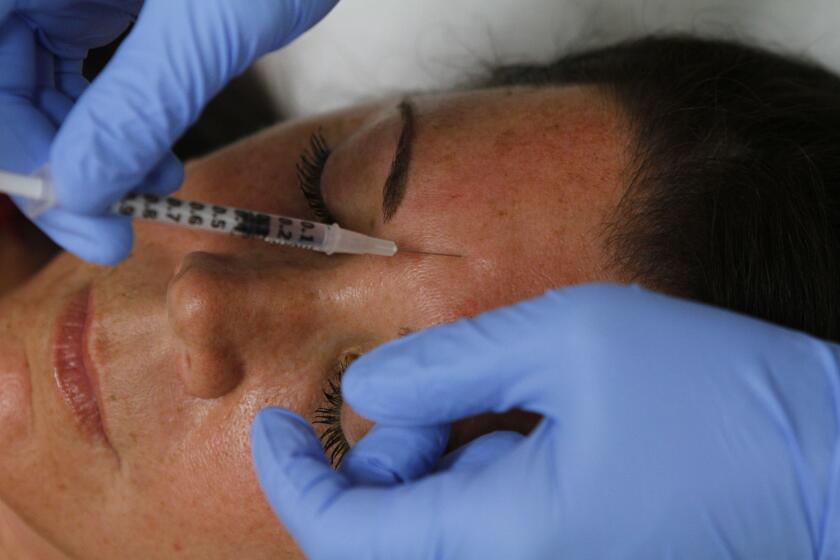 FILE Ñ A woman receives injections of Botox in Scottsdale, Ariz., Aug. 12, 2010. Federal and state health officials are investigating a spate of illnesses linked to counterfeit or improperly administered Botox that has sickened 22 people across 11 states. (Joshua Lott/The New York Times)