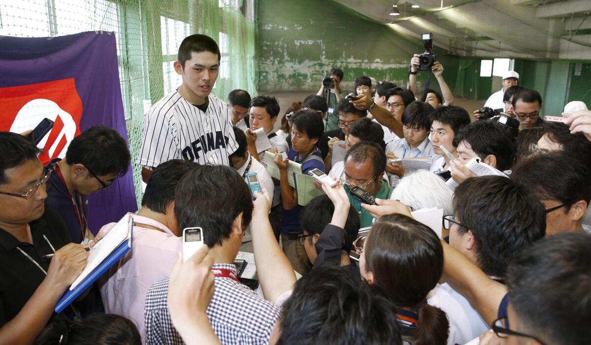 High school pitcher Rouki Sasaki speaks to reporters after a game July 16 in Hanamaki, Japan. He has drawn comparisons to the Angels' Shohei Ohtani.