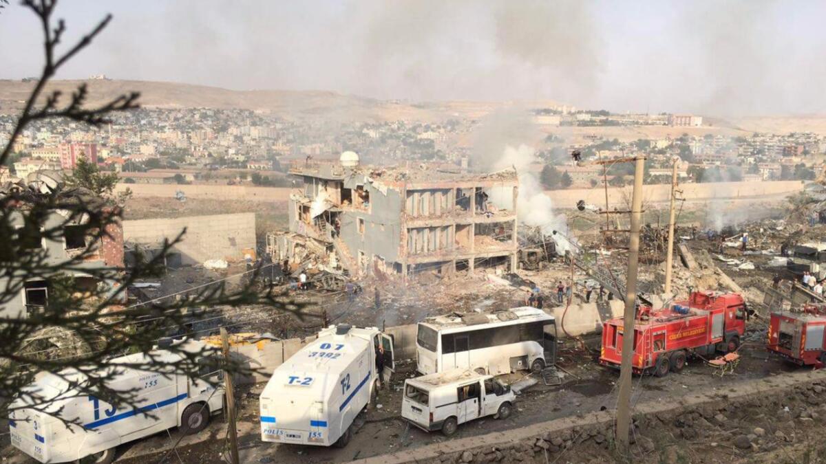 Police and firefighters gather at the scene of bomb attack near Cizre, Turkey, on Aug. 26.