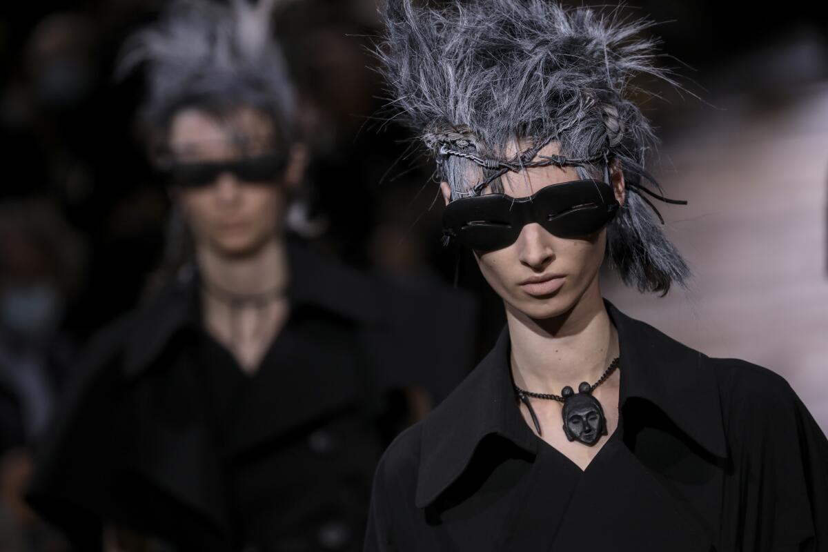 Models wear creations for the Yamamoto Spring-Summer 2022 ready-to-wear fashion show in Paris, Friday, Oct. 1, 2021. (Photo by Vianney Le Caer/Invision/AP)