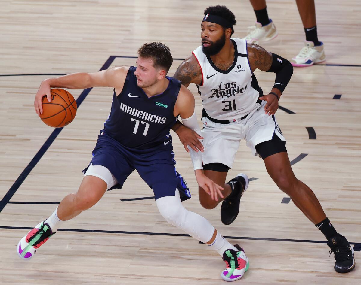 Dallas' Luka Doncic is defended by Clippers forward Marcus Morris Sr. during their playoff series.