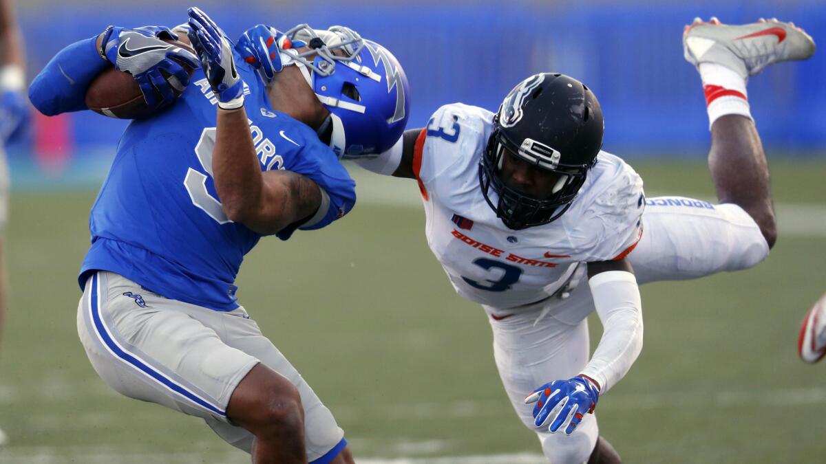 Boise State safety Chanceller James tackles Air Force wide receiver Jalen Robinette by the facemask during the second half Friday, drawing a penalty.