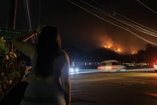 MENTONE, CA - SEPTEMBER 9, 2024: Mentone residents with the Line fire burn on a ridge above Highway 38 on September 9, 2024 in Mentone, California. (Gina Ferazzi / Los Angeles Times)