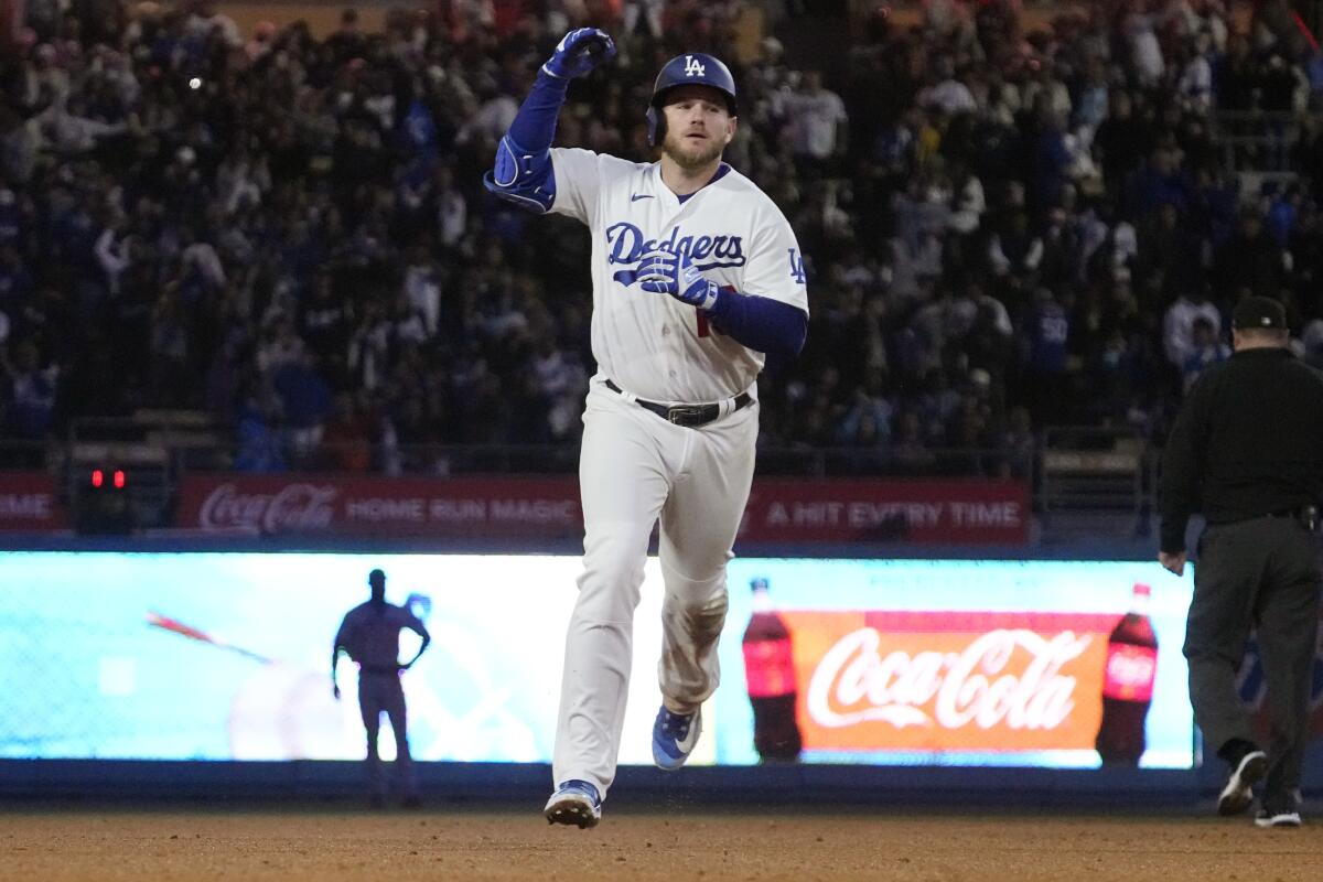 Max Muncy celebrates as he runs the bases after hitting a solo home run in the sixth inning.