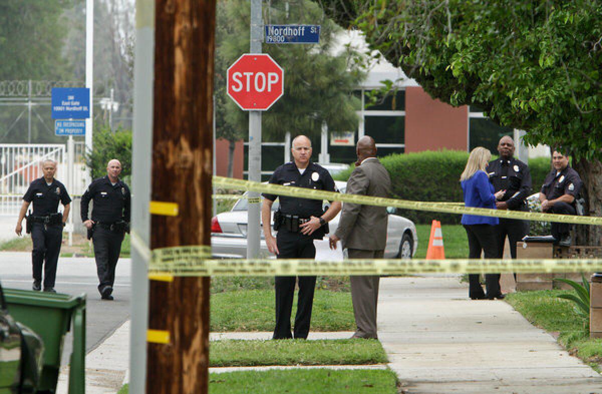 LAPD officers and detectives gather on the 8800 block of Oakdale Avenue in Northridge, where a 10-year-old girl dissapeared from her home.