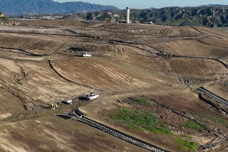 Castaic, CA - February 22: An aerial view of a workers overseeing a network of tubing that extract contaminated or polluted water to fill roughly 100 metal storage containers, holding up to 20,000 gallons each as the result of an underground landfill fire at Chiquita Canyon Landfill in Castaic Thursday, Feb. 22, 2024. Around 200,000 gallons of the contaminated water is coming out of the landfill each day. Environmental regulators have found elevated levels of cancer causing Benzine in the polluted water spilling onto the surface of the landfill. Landfill operators are also constructing a drainage system to capture the contaminated water that is spilling onto the surface and proactively pumping the water. Residents of Val Verde and Castaic are protesting to call for Chiquita Canyon Landfill to be closed in Hasley Canyon Park in Castaic. Garbage has been burning deep inside the landfill due to a chemical reaction for much of the past year, and recently scalding-hot contaminated water has surged to the surface. The protest follows calls from the County Supervisor Kathryn Barger's office, which said the landfill should provide funds to relocate residents who want to temporarily move until the issue is resolved. (Allen J. Schaben / Los Angeles Times)