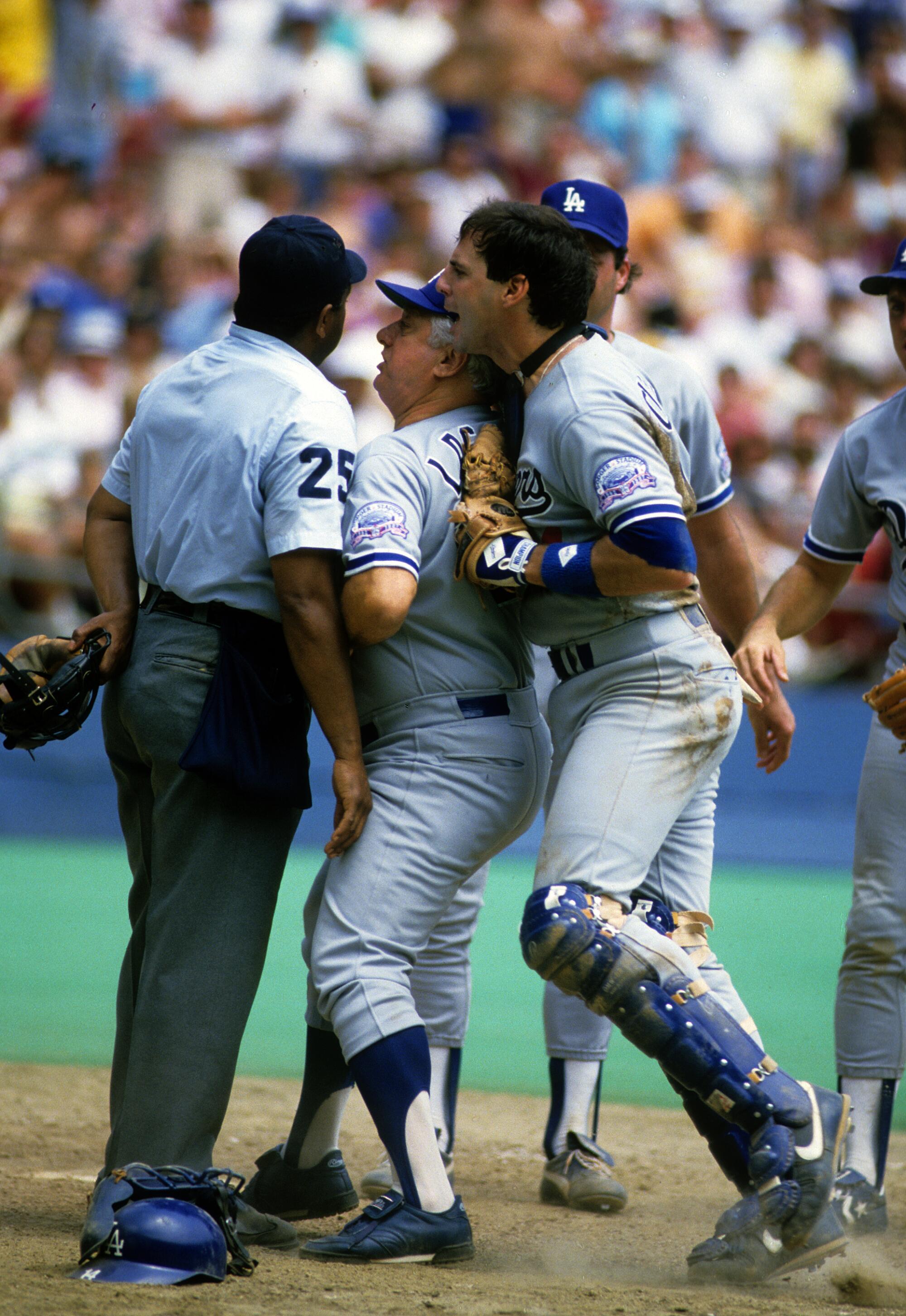 Tommy Lasorda is sandwiched between umpire Charlie Williams and Dodgers' Mike Scioscia arguing a call in 1987 in Pittsburgh.