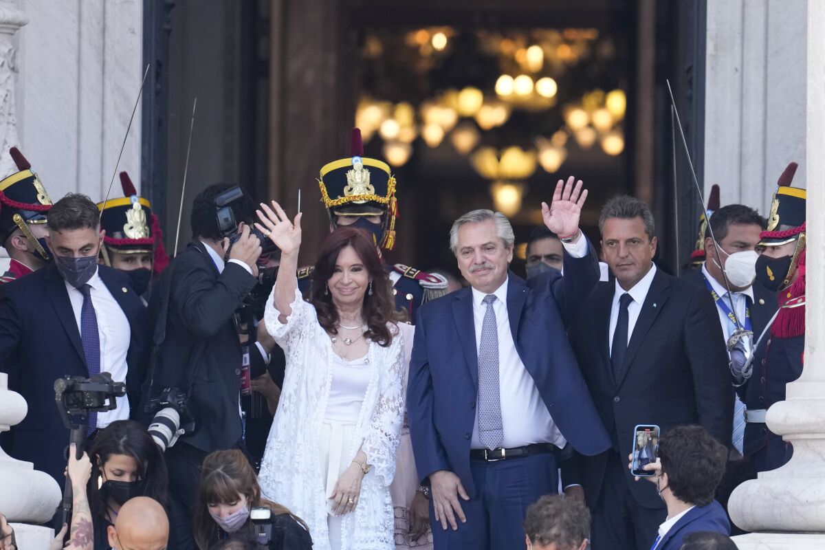 Argentina's Vice President Cristina Fernandez, left, and President Alberto Fernandez, wave after attending the ceremony marking the year's opening session of Congress in Buenos Aires, Argentina, Tuesday, March 1, 2022. Argentina’s government announced Thursday, March 3, that it reached a deal with the International Monetary Fund to refinance some $45 billion in debt, marking an attempt to stave off default and remove economic uncertainty that has hung over the country during two years of negotiations. (AP Photo/Natacha Pisarenko)