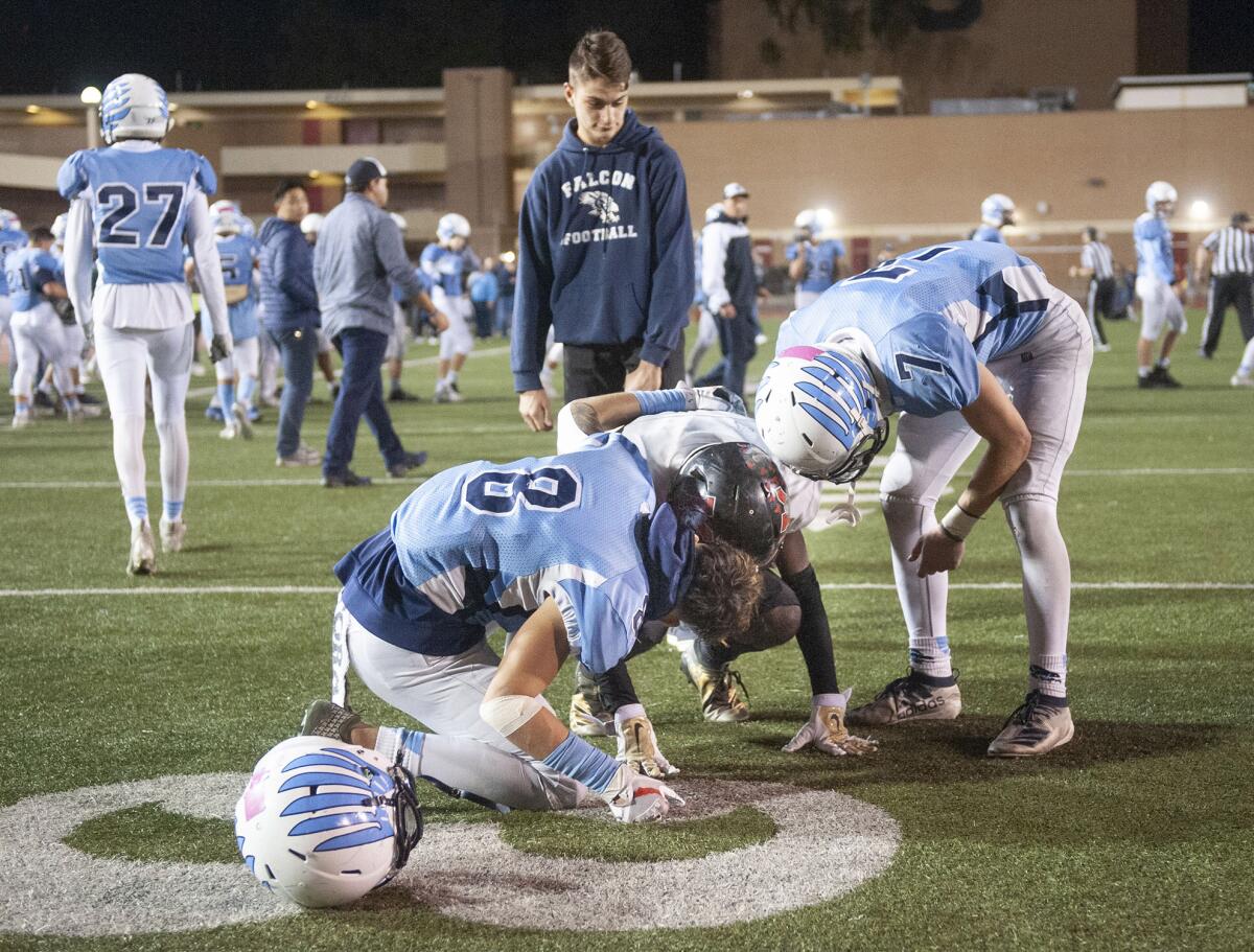 Crescenta Valley’s Angel Ochoa (8) and Colby Rees console Katella’s Ledell Stark at the end of during Friday's CIF Southern Section Division X semifinal playoff game at Moyse Field. (Photo by Miguel Vasconcellos)