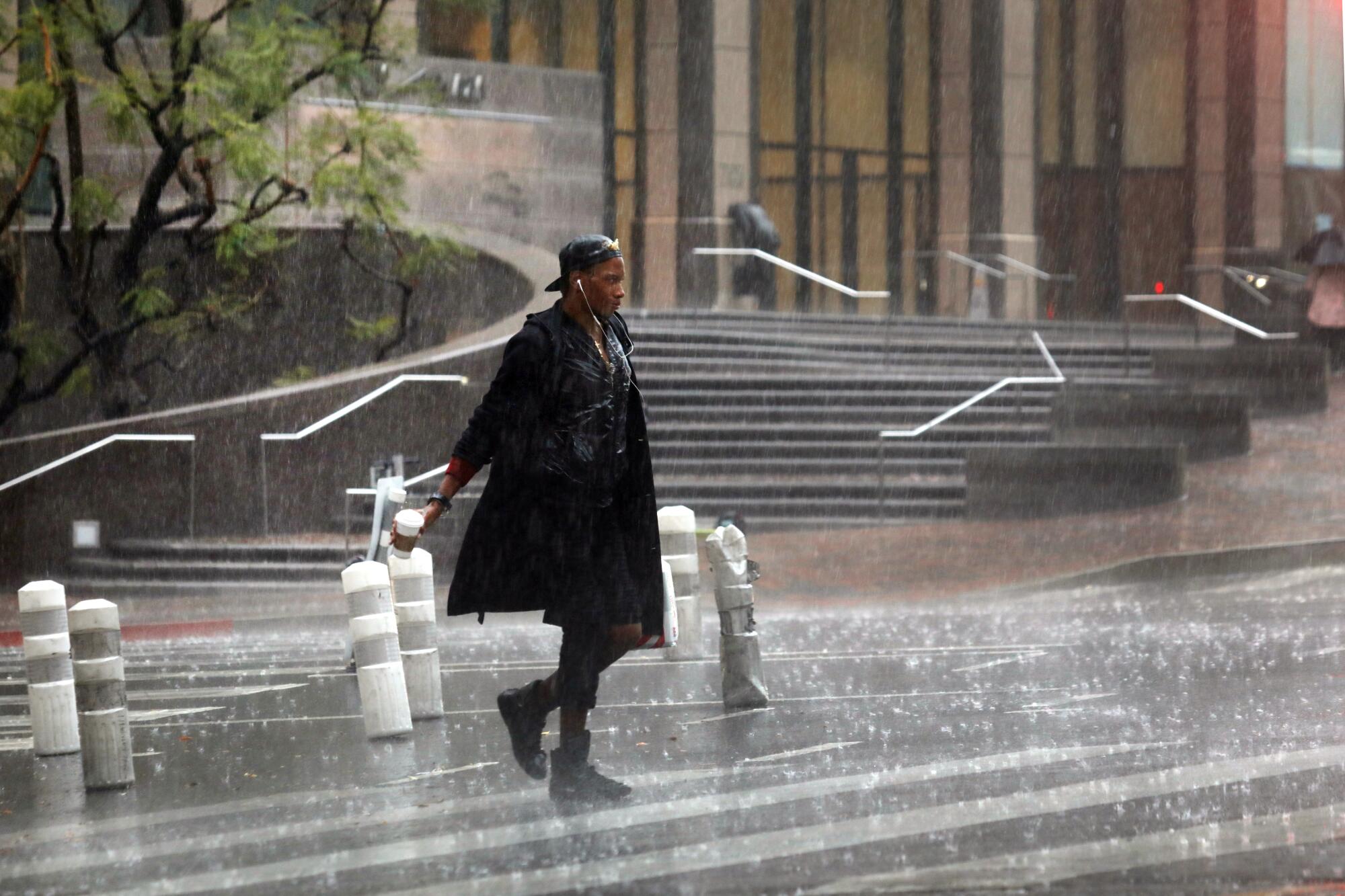 A person walks in heavy rain.
