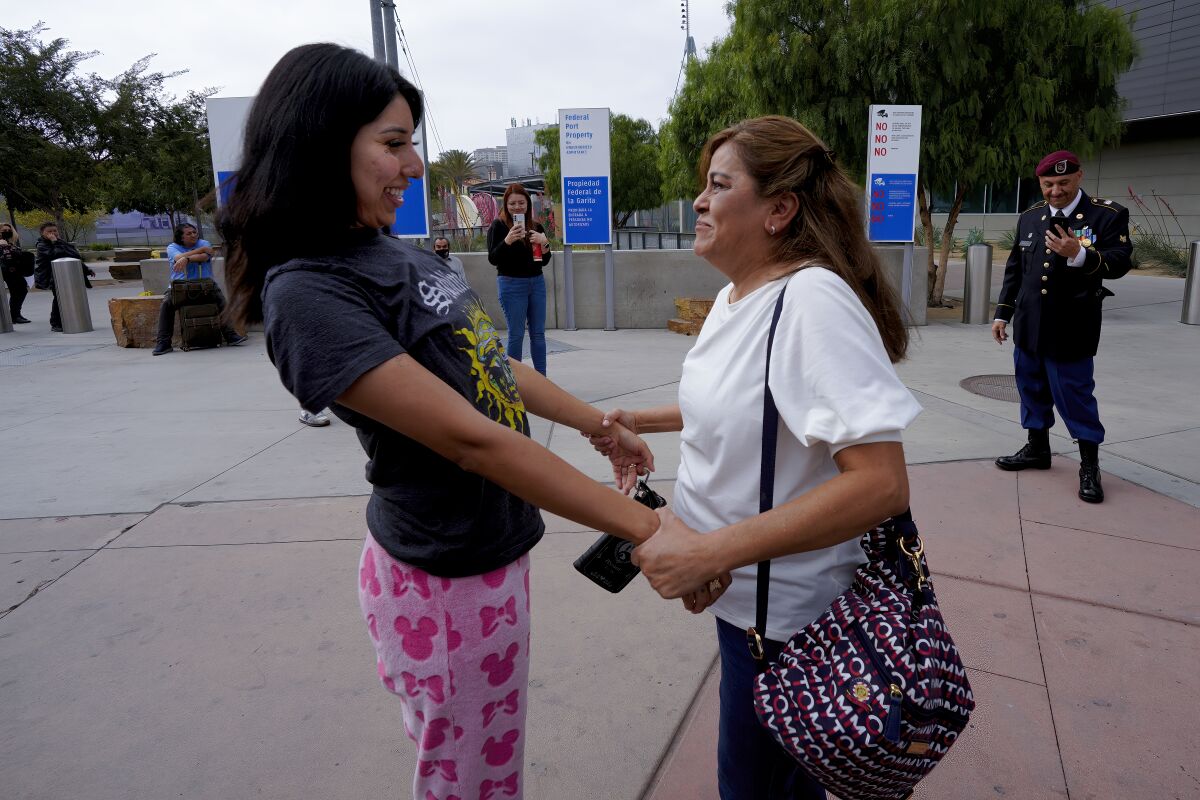 Yolanda Varona greets her daughter, Paulina Young. Varona's husband, Hector Barajas, a U.S. Army veteran, stands nearby.