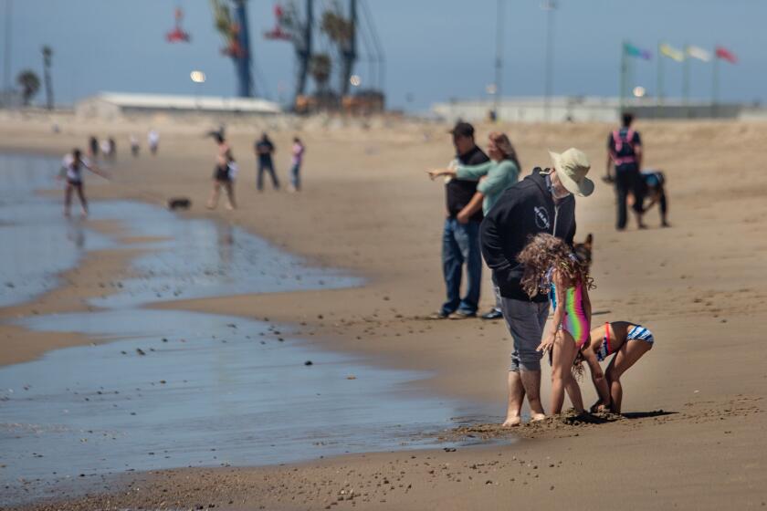 PORT HUENEME, CA - APRIL 19: People enjoy a day at the beach after Ventura County modified its coronavirus stay-at-home order to permit some businesses to reopen and some activities and gatherings at Port Hueneme Beach Park on Sunday, April 19, 2020 in Port Hueneme, CA. (Jason Armond / Los Angeles Times)