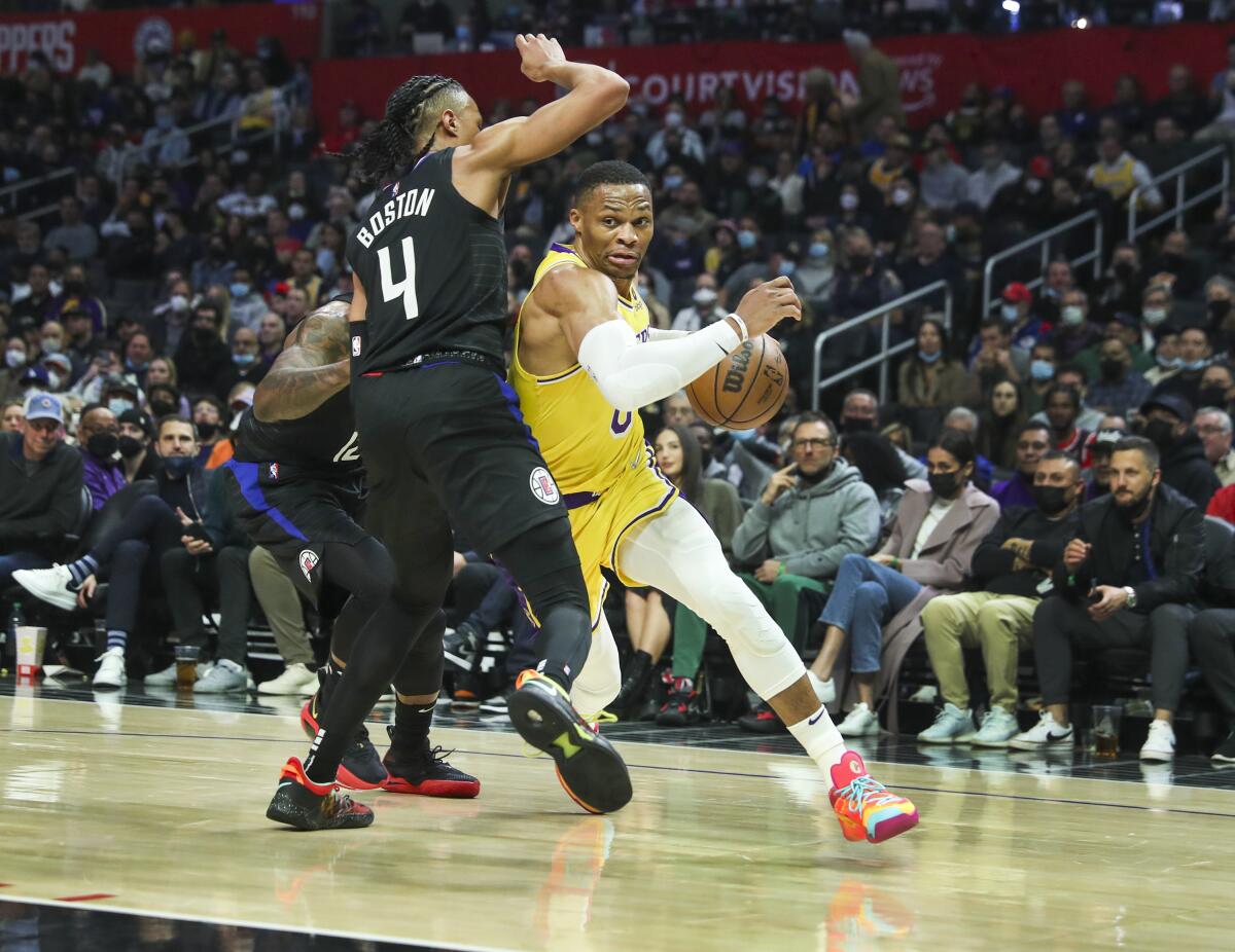 Lakers guard Russell Westbrook tries to drive around Clippers guard Brandon Boston Jr.