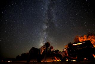 AUGUST 12, 2013. ANZA BORREGO STATE PARK, CA. Sue and John Schafer, on a tour with California Overland Desert relax on a dry lake bed in the Anza-Borrego Desert State Park and wait for the Perseid Meteor Shower to unfold. The cloud-like Milky Way glows overhead. Exposure data: 30 sec @f.2.8, 16mm lens on a Canon EOS 5D Mark III digital camera set at ISO 2500. (Don Bartletti / Los Angeles Times)