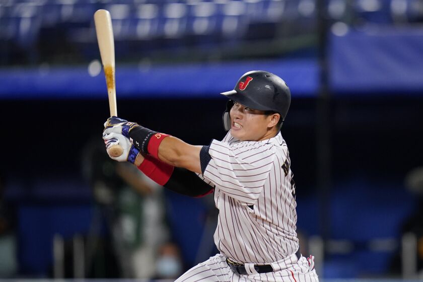 FILE - Japan's Munetaka Murakami hits a home run during the gold medal baseball game against the United States at the 2020 Summer Olympics, Aug. 7, 2021, in Yokohama, Japan. Murakami, playing for the Tokyo-based Yakult Swallows, hit his 56th home run of the season on Monday, Oct. 3, 2022, pushing him alone into second place on the single-season home run list. It was the Swallows' last regular-season game. (AP Photo/Sue Ogrocki, file)